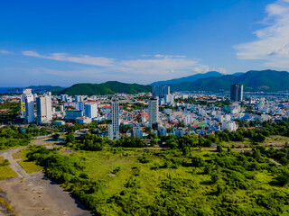 Obraz premium Flying over a coastal city. Nha Trang tourist city. Asian architecture of the central part of the city. 