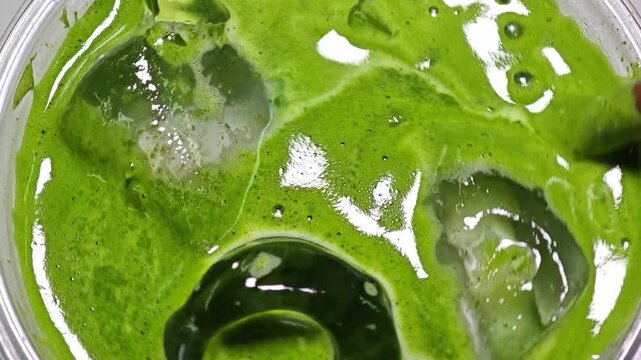 Smooth iced matcha latte. Close up.