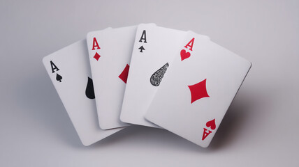 Obraz premium Four aces playing cards with spade, diamond, club and heart suits on a grey background, playing cards on a white background, four aces , ace of heartsx, royal flush poker cards, royal flush of spades,