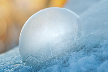 Frozen Soap Bubble in the Snow with Warm Sunlight from Behind