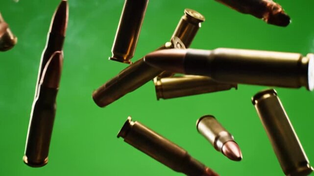 Close-animated movie on multiple equipment bullets with copper tips and brass casings against a vibrant green background