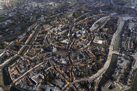Aerial view of a circular town with red rooftops and canals under the soft sunlight, Middelburg, Zeeland, Netherlands.