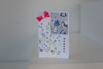 Handmade greeting card with floral decor and ribbon bow