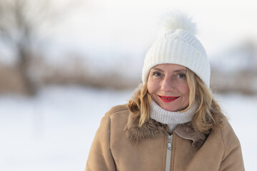 Fototapeta premium happy woman with white hat enjoying winter outdoors