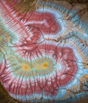 Aerial view of layered rock formations reveal a tapestry of red, white, yellow, and brown hues etched by erosion, a captivating natural canvas, Mangistau, Mangystau Region, Kazakhstan.