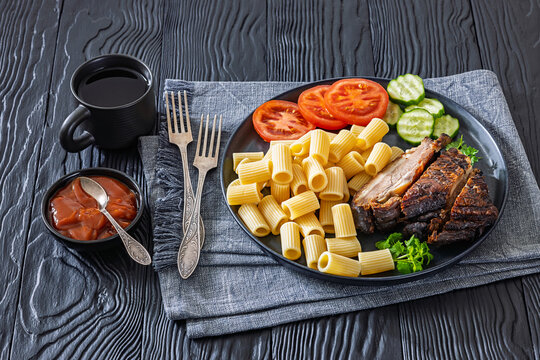 roasted pork ribs with pasta and fresh vegetables