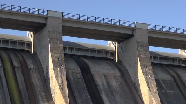 Dam concrete sluice spillway flood gate reservoir lake Sant Ponc afternoon water