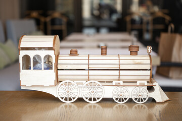 Wooden toy train model on table in cafe interior