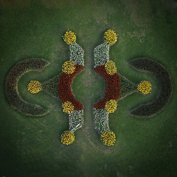 Aerial view of meticulously arranged flowerbeds, their vibrant colors and geometric patterns creating a stunning visual symphony from above, Parc de l'Independance, Morges, Vaud, Switzerland.
