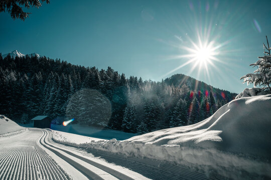 Sunny winter landscape with cross-country ski trail in the Tyrolean Alps