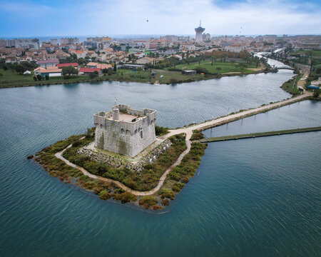 Aerial view of the imposing stone fortress of Redoute de Ballestras standing proudly on its small island, surrounded by serene waters, Palavas-les-Flots, Occitanie, France.