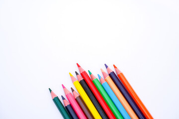 Fototapeta premium A fan of colorful pencils arranged on a white background