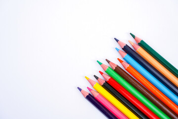 Fototapeta premium colorful pencils arranged in a row on a white background
