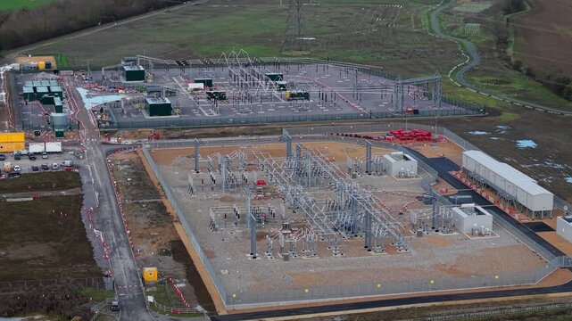 Aerial view of the Biggleswade National Grid 400/132kV Substation, an industrial landscape with power lines and buildings, Biggleswade, Biggleswade, United Kingdom.