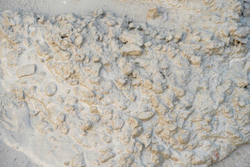 close up textured background of wet cement mixture with aggregates