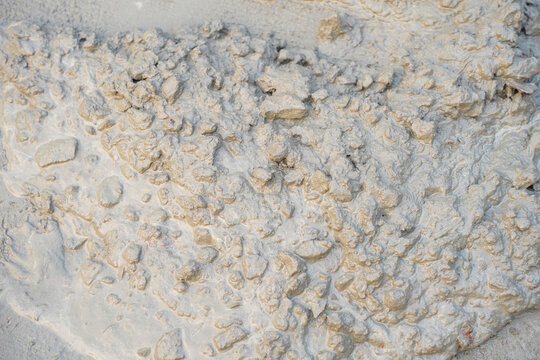 close up textured background of wet cement mixture with aggregates