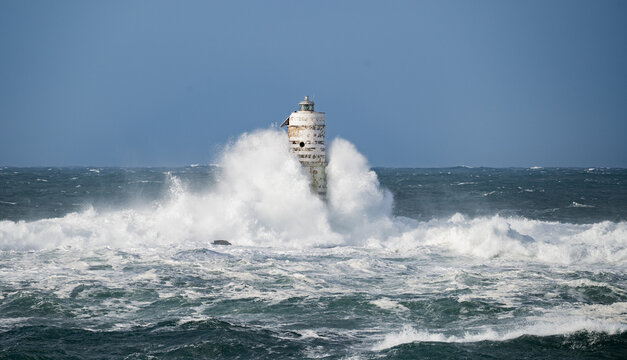 Storm waves crashing against Mangiabarche lighthouse, Calasetta South Sardinia