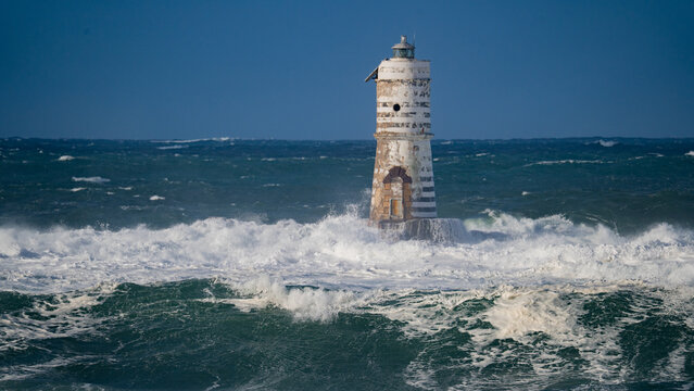 Storm waves crashing against Mangiabarche lighthouse, Calasetta South Sardinia