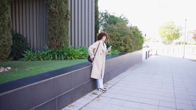 A fashionable and stylish individual is seen in a contemporary and modern urban setting