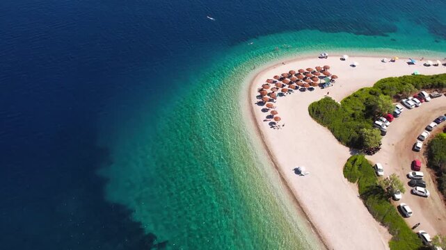 Aerial Reveal of Agios Dimitrios Beach in Alonissos &mdash; Cinematic Drone Shot Starting from Sunbeds at Sandspit Tip to Turquoise Sea Panorama, Sporades Islands Greece