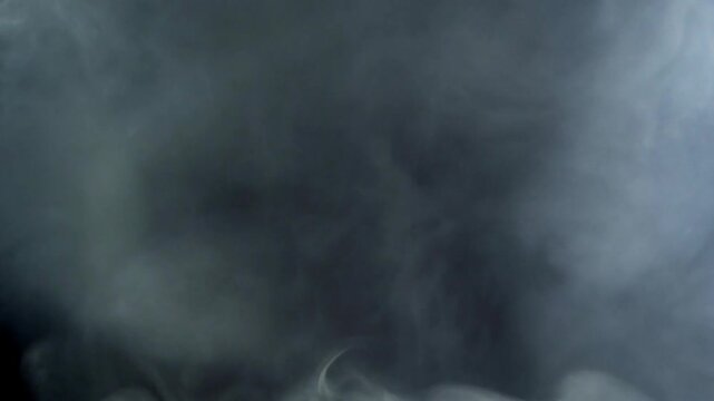 Dense White Smoke Cloud Swirling on Black Background, Atmospheric Motion