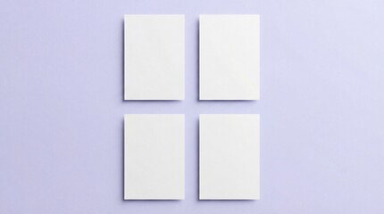 Fototapeta premium Four blank white business card mockups on soft purple background