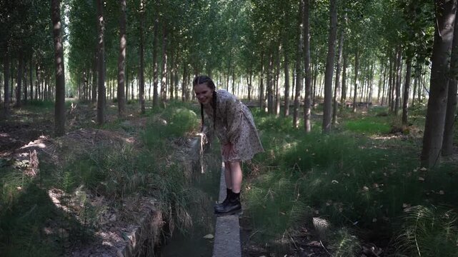 A young woman journeying through a tranquil forest path filled with natures beauty and peace