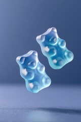 two blue gummy bears floating in the air, dark blue background