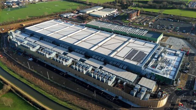 Aerial view of the sprawling Google data centre, a modern industrial complex with a solar panel array on the roof, Waltham Cross, United Kingdom.