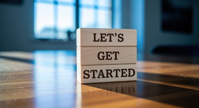 Let's Get Started Message on Wooden Blocks Resting on a Polished Table with Window Light