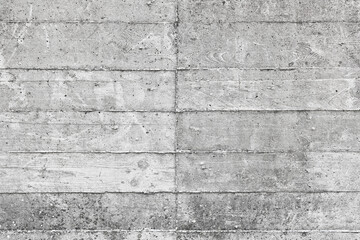 Fototapeta premium EXPOSED CONCRETE WALL SURFACE WITH FORMWORK MARKS AND SEAMS - GRAY CEMENT MATERIAL WITH ROUGH INDUSTRIAL CONSTRUCTION TEXTURE, WEATHERED URBAN FACADE, SOLID BUILDING STRUCTURE AND MASONRY SURFACE
