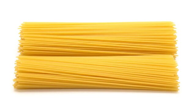 Dry spaghetti on white background.