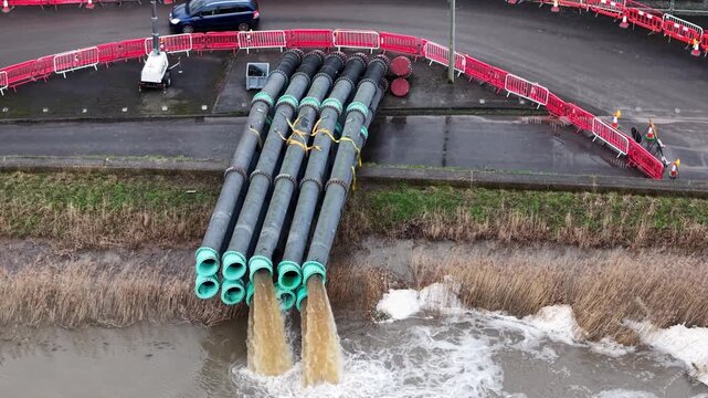Zoomed-in view of emergency flood pumping operations at North Moor Pumping Station on Northmoor Green Moorland in Bridgwater, Somerset. High-capacity pumps work continuously to control floodwater leve