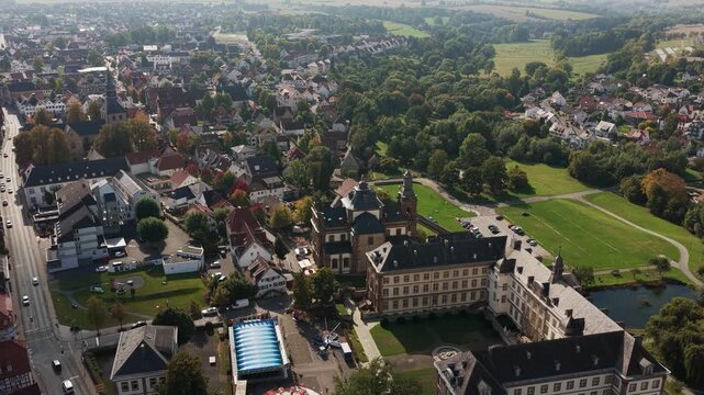 Aerial view of the Baroque Jesuit Church and Mauritius Gymnasium in Buren, Germany, surrounded by a historic townscape.