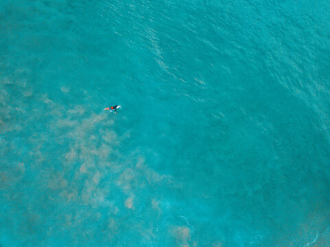 Distant Aerial view of a man surfing in the ocean, Cronulla, New South Wales, Australia