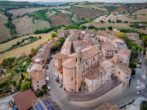 Aerial view of the ancient town with terracotta roofs and winding streets nestled among rolling green hills, Magliano di Tenna, Province of Fermo, Italy.