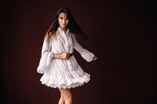 girl in a white dress with a lace whirling and look at camera. p