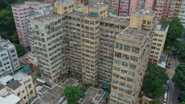Old apartment buildings crammed together in urban area, trees, street