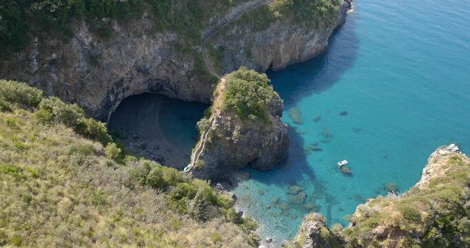 Aerial view of the Arcomagno of San Nicola Arcella on the Tyrrhenian coast of Calabria, Italy. It's a geological formation located along the beautiful italian coast. It has a crystal and turquoise sea