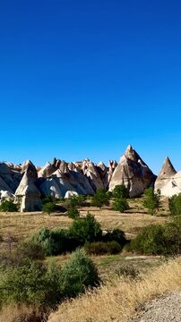 Cresting a Hill and Seeing Cappadocia Landscape with Bizarre Rock Formations (Goreme, Cappadocia, Turkey)