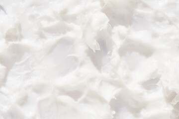 Obraz premium Creamy white texture background with soft, swirling patterns for beauty and skincare themes.