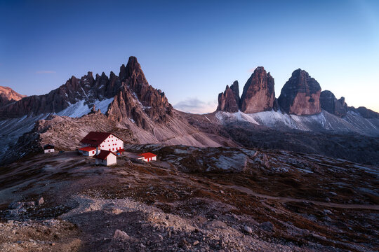 Scenic view of Tre Cime di Lavaredo peaks and rifugio locatelli mountain hut in the dusk at Dolomites, italy