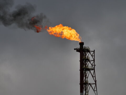   refinery fire gas torch on sky background