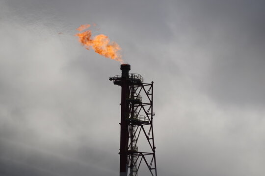   refinery fire gas torch on sky background