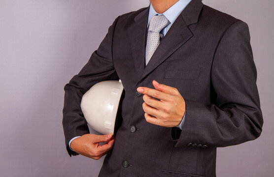 Business Engineer Holding Safety Helmet in Formal Suit