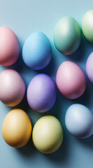 Brightly colored eggs in pastel shades are placed in a straight line on a soft surface. These eggs are commonly used during Easter for decoration and festivities