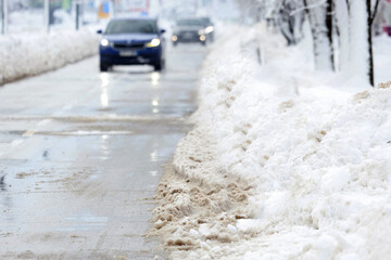 Snow Covered Road with Winter Traffic and Snowbanks