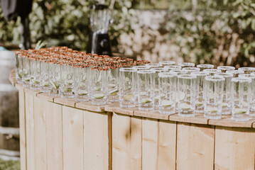 Empty glasses with cjilli seasoning on a garden or outdoor bar wait to be poured