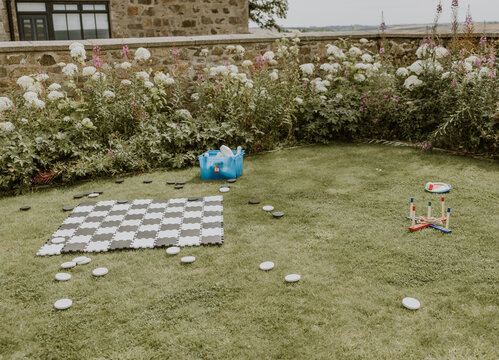 Garden games laid out on a lawn including chess and hoopla