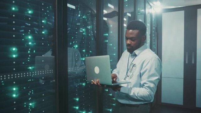 Dedicated IT specialist oversees security and server operations throughout nighttime shifts in data centers